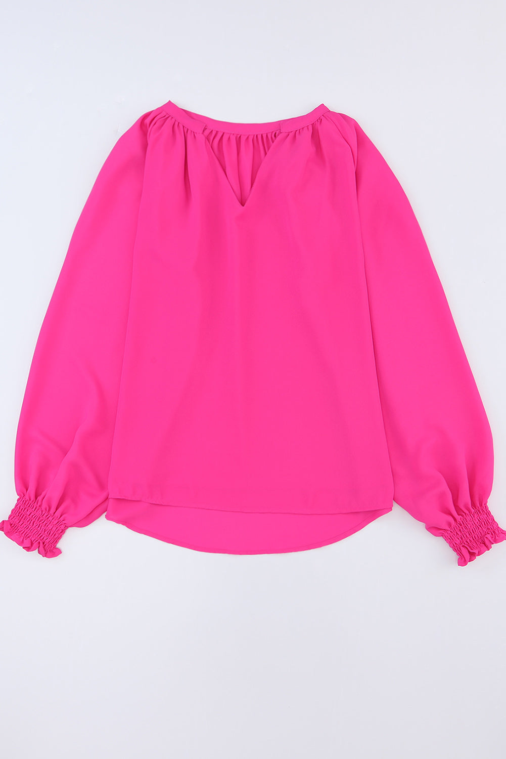 Blouse plissée rose à col en V et manches bouffantes