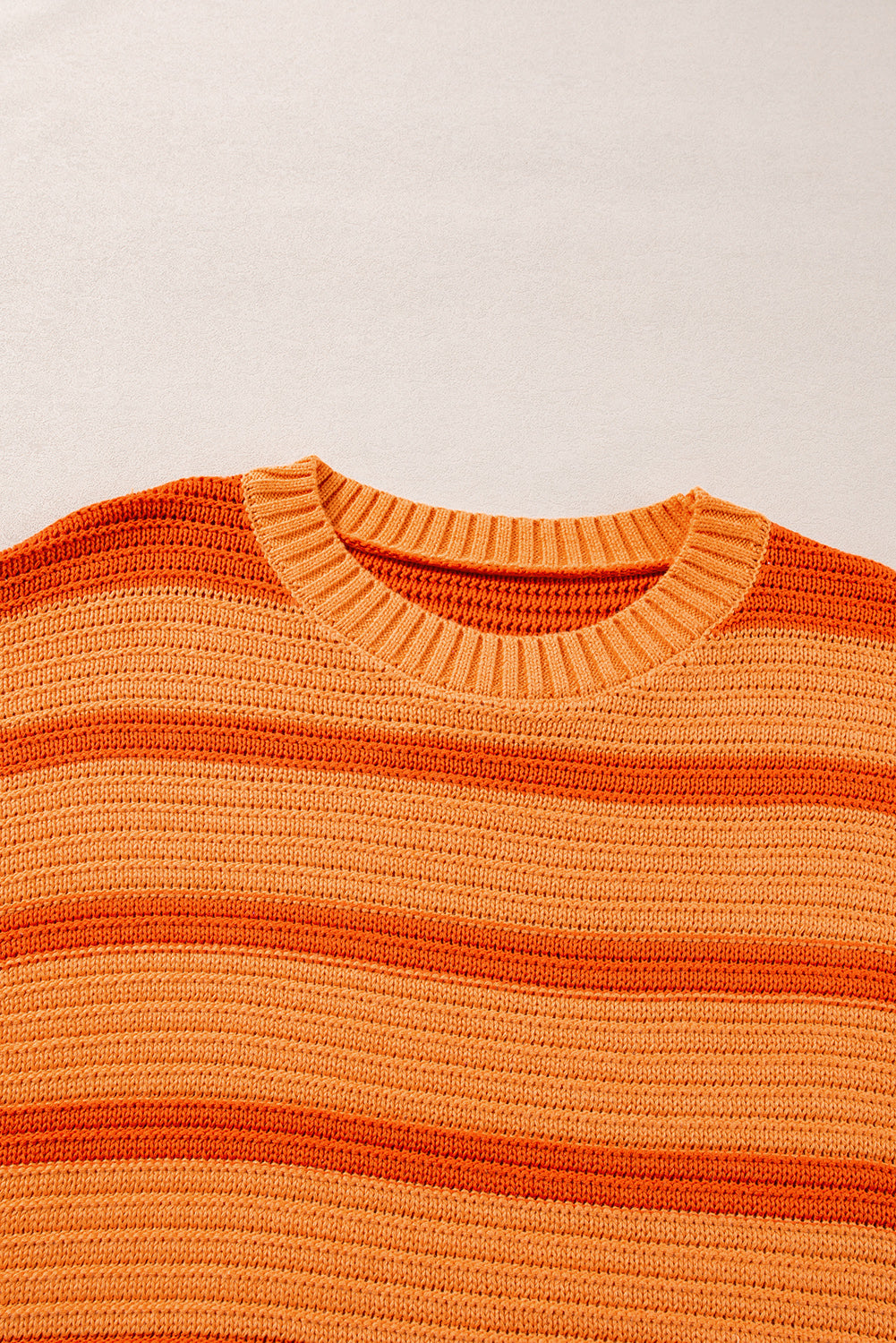 Loose sweater with orange stripes and color block, round neck, dropped shoulders