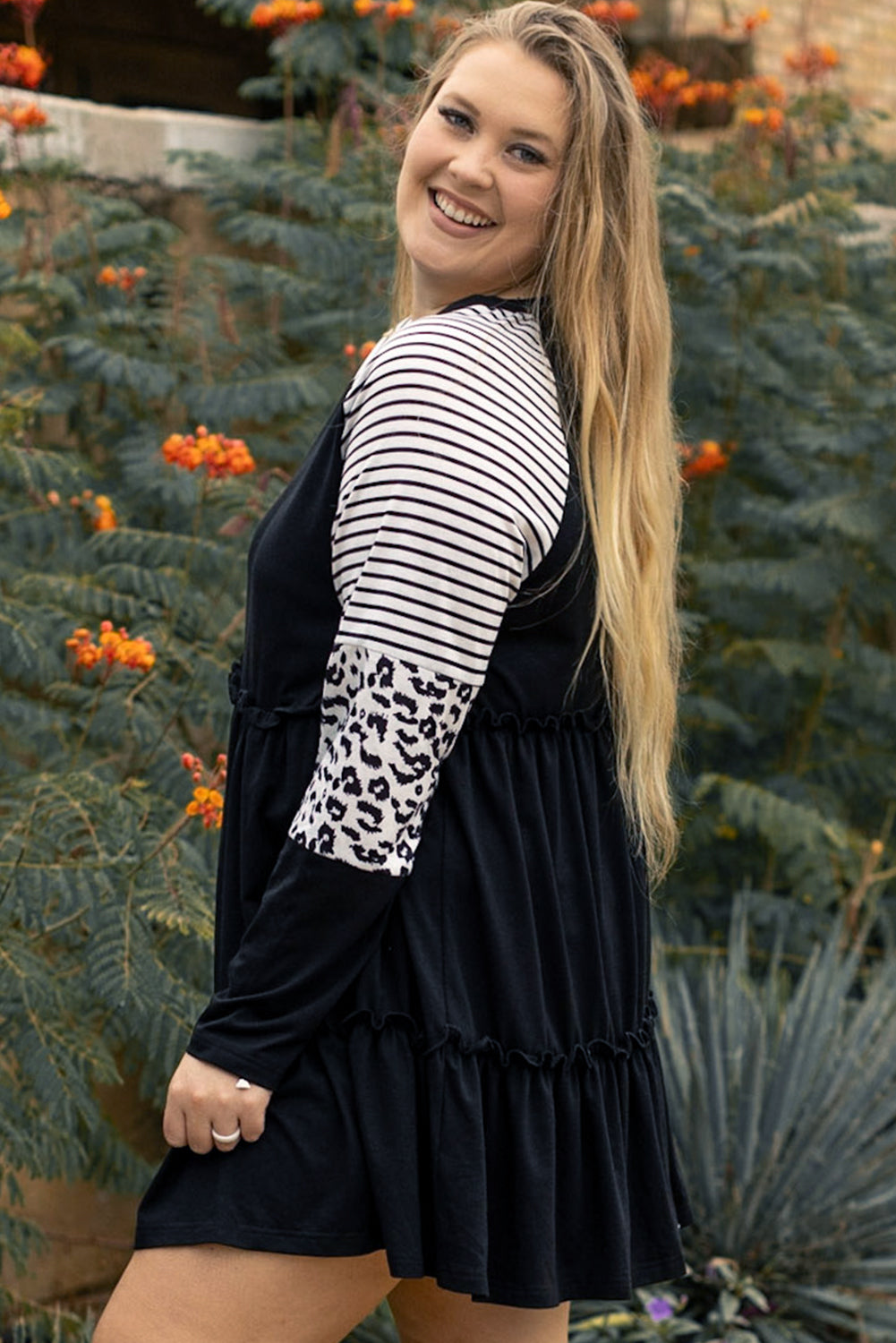 Striped black dress with ruffles and large leopard patch patch sleeves