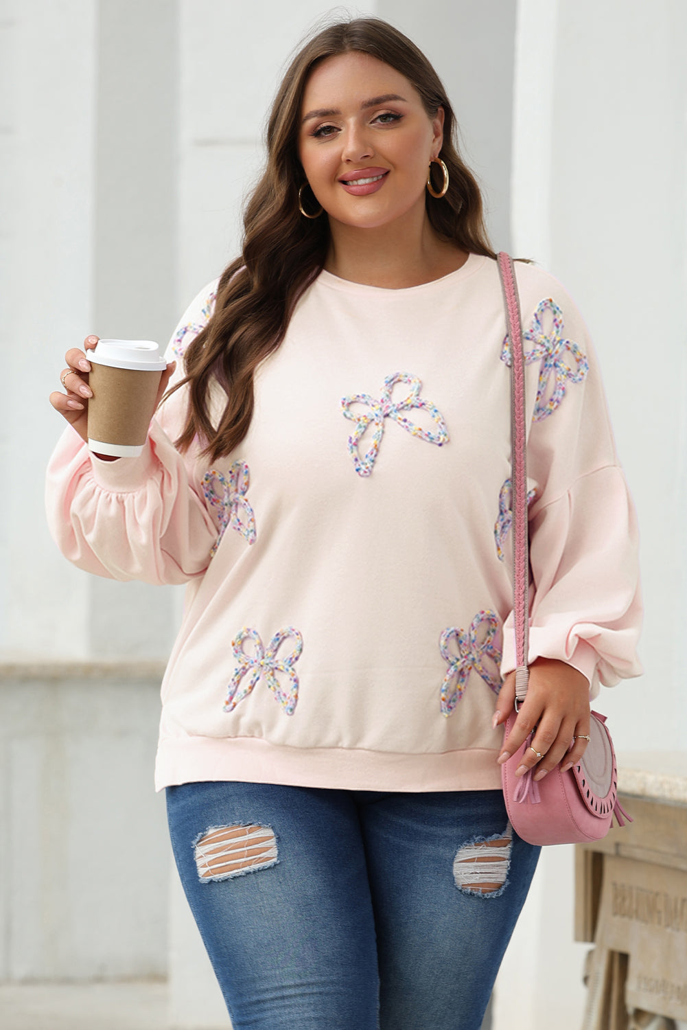 Oversized sweatshirt with lantern sleeves and parchment embroidered bow