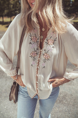 Beige loose shirt with puffy textured sleeves embroidered with flowers