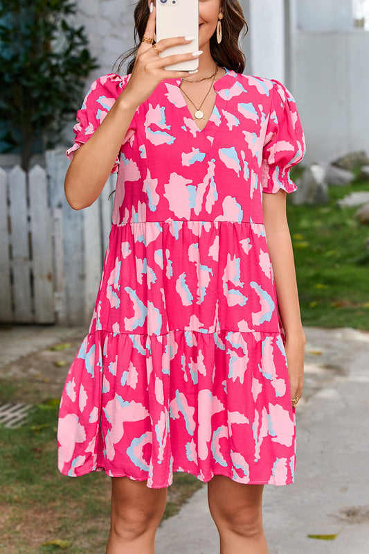 Tiered loose dress with short puff sleeves and pink abstract print