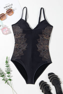 Black swimsuit with thin suspenders and crossed petals on the back