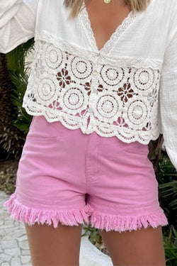 Mid-rise pink denim shorts with frayed edges