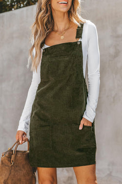 Sleeveless velvet overall dress with vineyard green pockets before