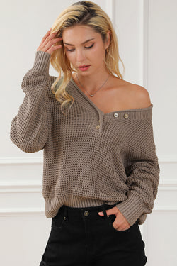 Khaki tricot sweater buttoned with V -neck button and drooping shoulders