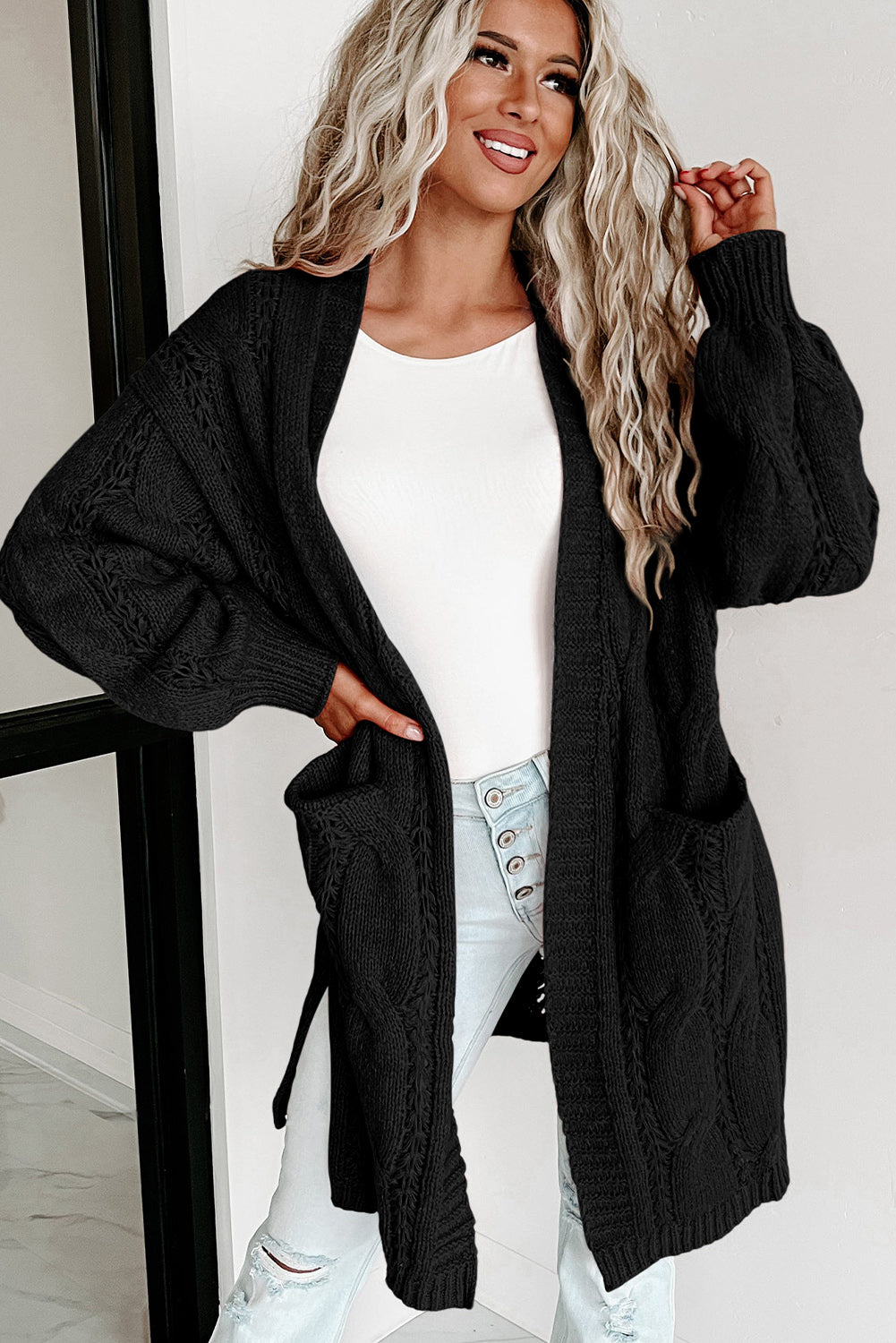 Cardigan noir en maille torsadée à œillets et bordures côtelées-A WOMAN WE LOVE