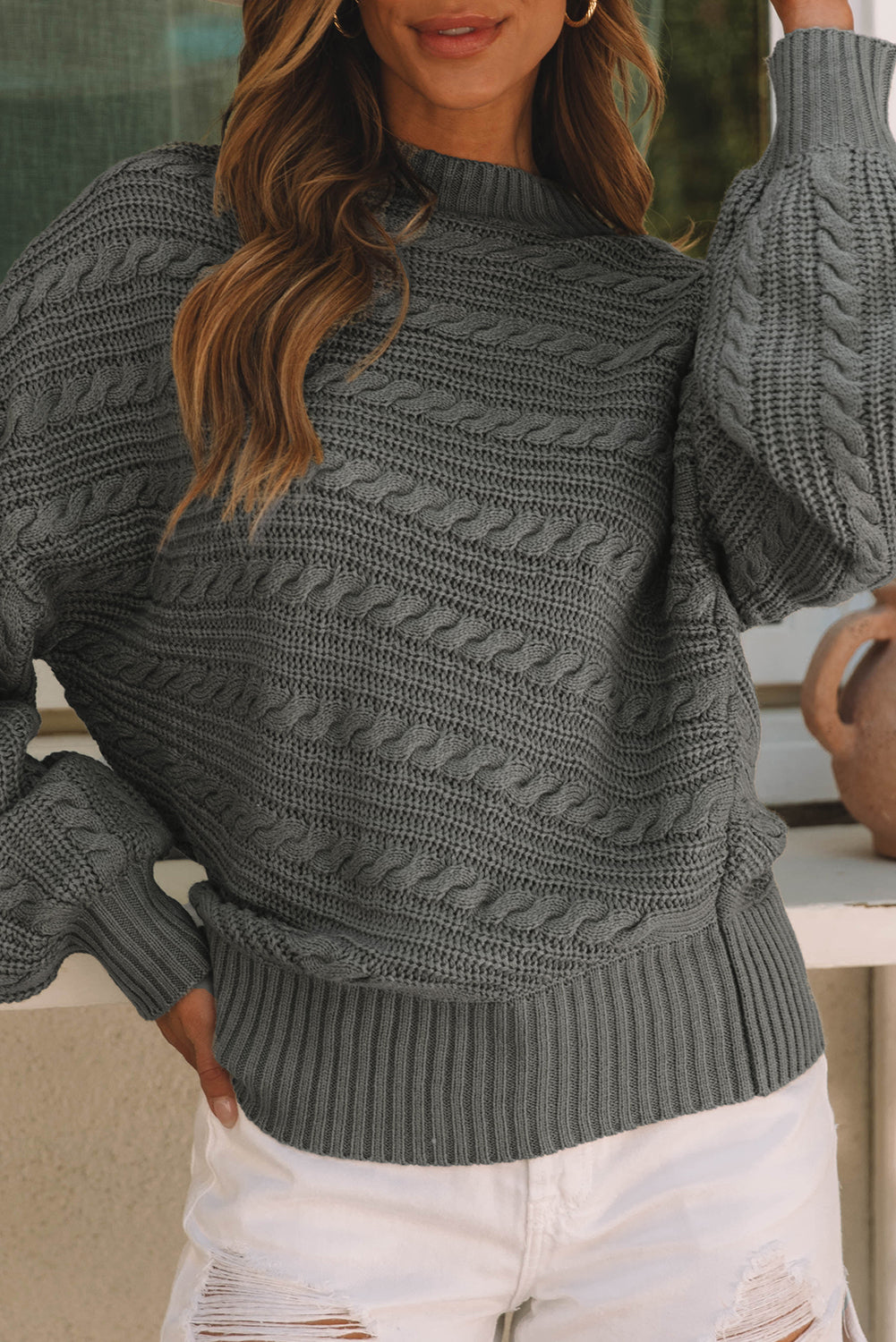 Gray cable knit sweater with lantern sleeves and high neck