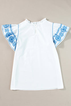 White blouse embroidered with fluffy sleeves and ruffle collar