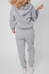 Set of plain gray sports clothing with hooded and jogging with exposed seams