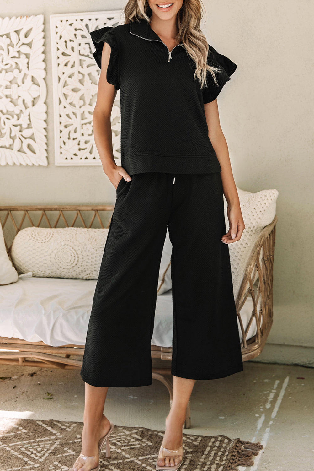 Black textured top and wide leg pants set with flutter sleeves