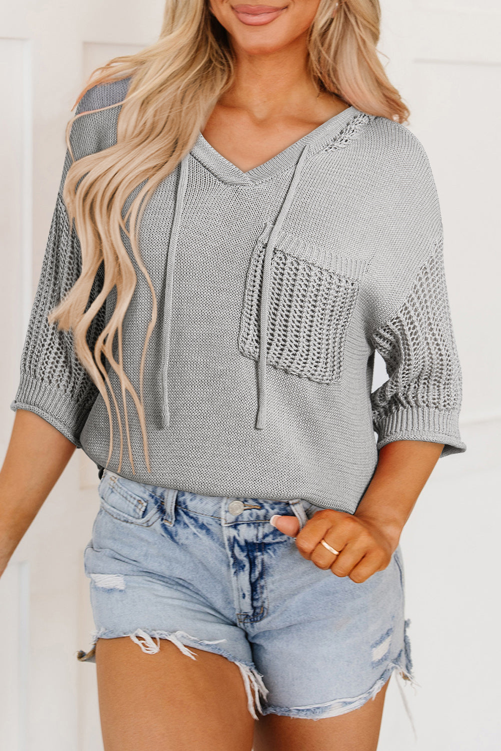 Light gray short sleeve pullover top with hood and openwork drawstring