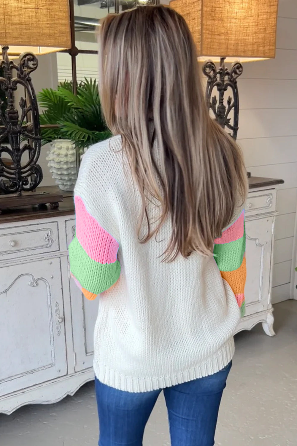 Crew neck sweater with color block sleeves and white floral pattern