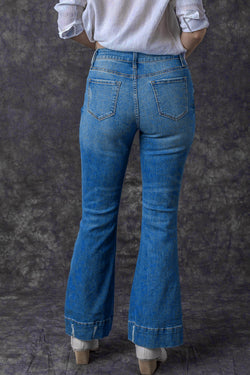 Lightly distressed sky blue flared jeans with a medium wash