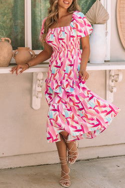 Smocked pink dress with ruffles and brush kick print