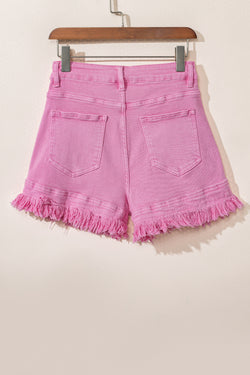 Mid-rise pink denim shorts with frayed edges