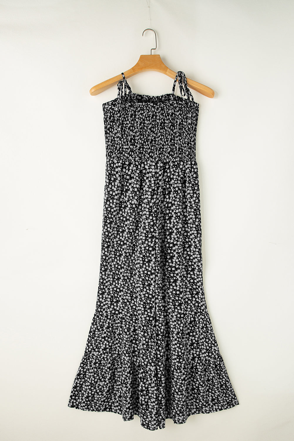 Black floral jumpsuit with thin straps and smocked bodice