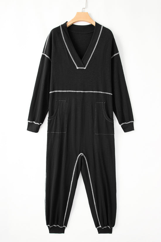 Black baggy jumpsuit with v-neck and flat seam details