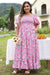 Smocked pink dress with puffy sleeves and large floral print