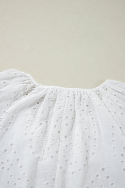 White blouse with puffy sleeves and V -collar embroidered with eyelets