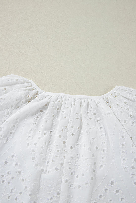 White blouse with puffy sleeves and V -collar embroidered with eyelets