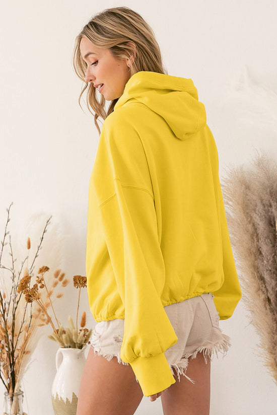 Sweat à capuche zippé jaune avec poche kangourou et bordure côtelée