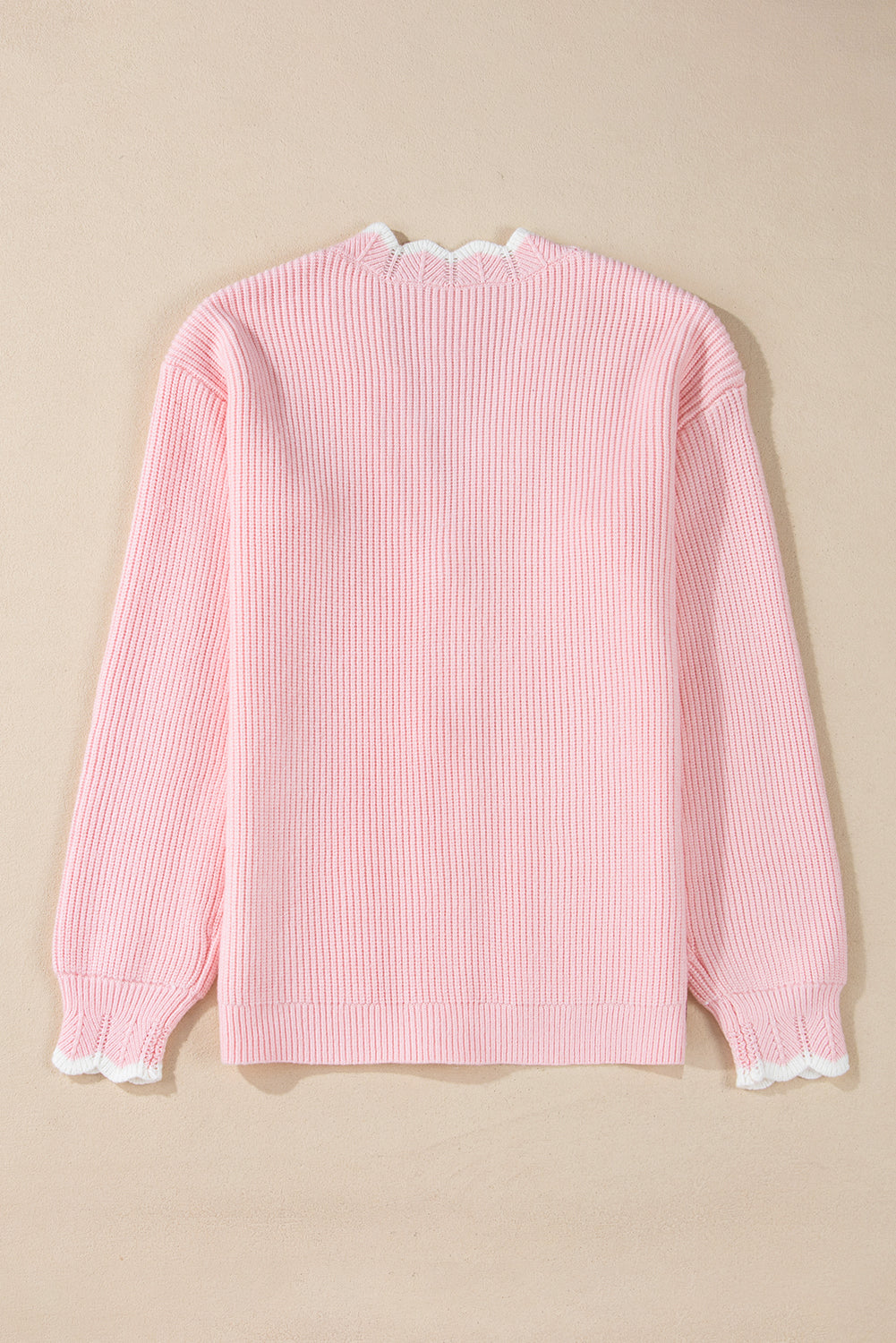 Pink ribbed knit button-up cardigan with side pockets and scalloped edges