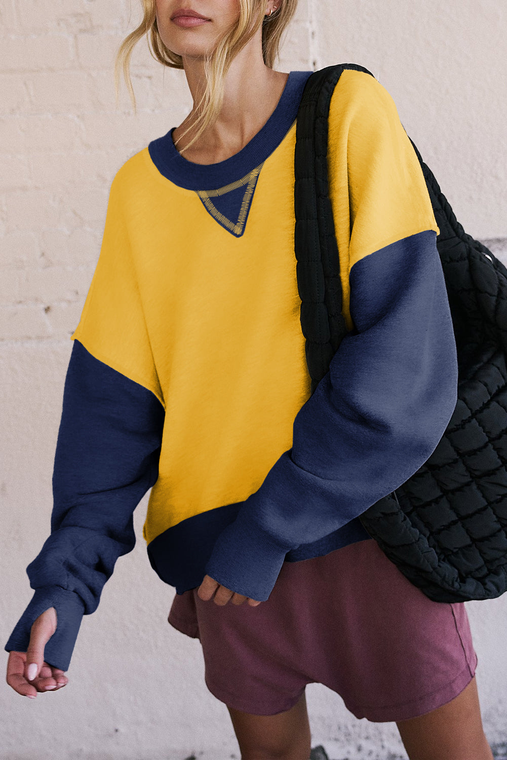 Yellow sweatshirt with dropped shoulders and sleeves with thumb hole