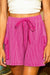 Large shorts with bright pink cargo pocket