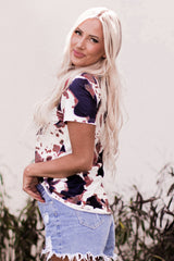 White T-shirt with short sleeves and V-neck printed with cow pattern