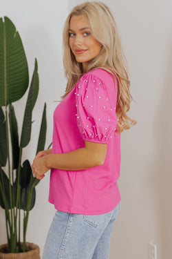 Bright ribbed pink with puffy sleeves and pearls *