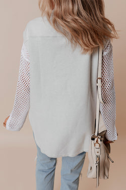 Light grey jacket with flap pockets and contrasting buttons on the front