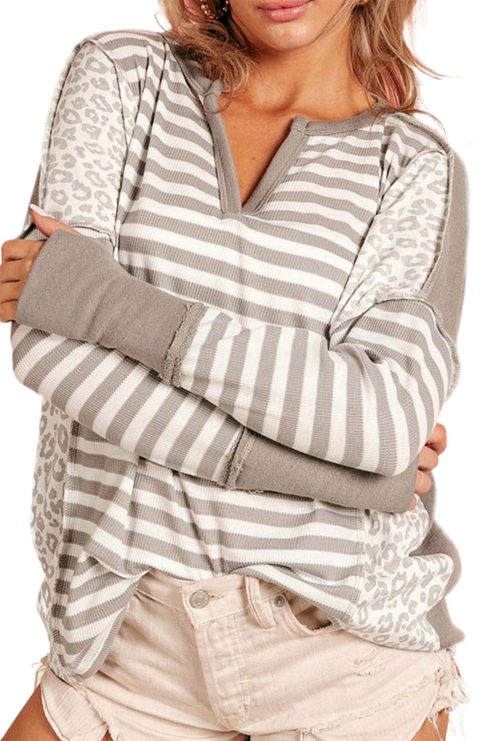 White top with sleeves with thumbhole and leopard striped patch