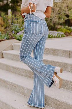 Flared jeans torn with vertical blue sky stripes