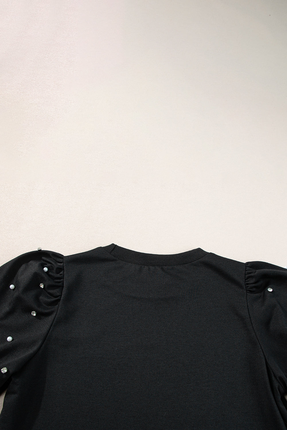 Black top with mid-long puffing sleeves with pearls and rhinestones