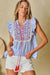 Striped fringed blouse with geometric pattern with sky blue stripes