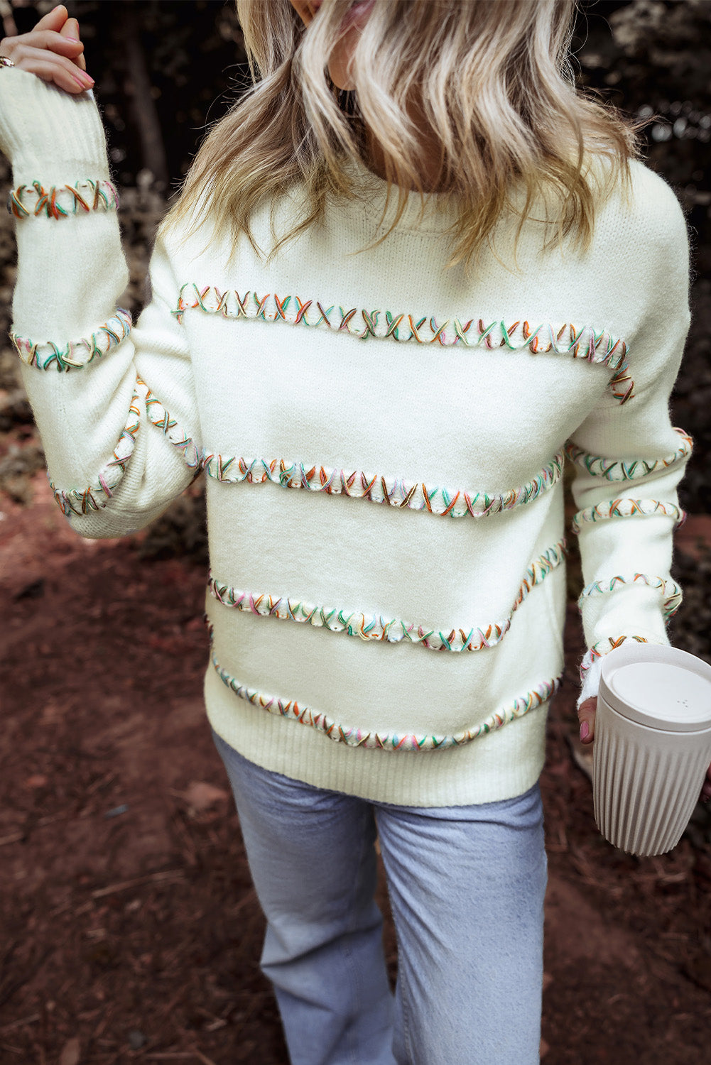 Colorful white sweater with dropped shoulders and crossed stitches