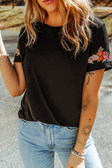 Black T-shirt with short sleeves and round neck embroidered with flowers