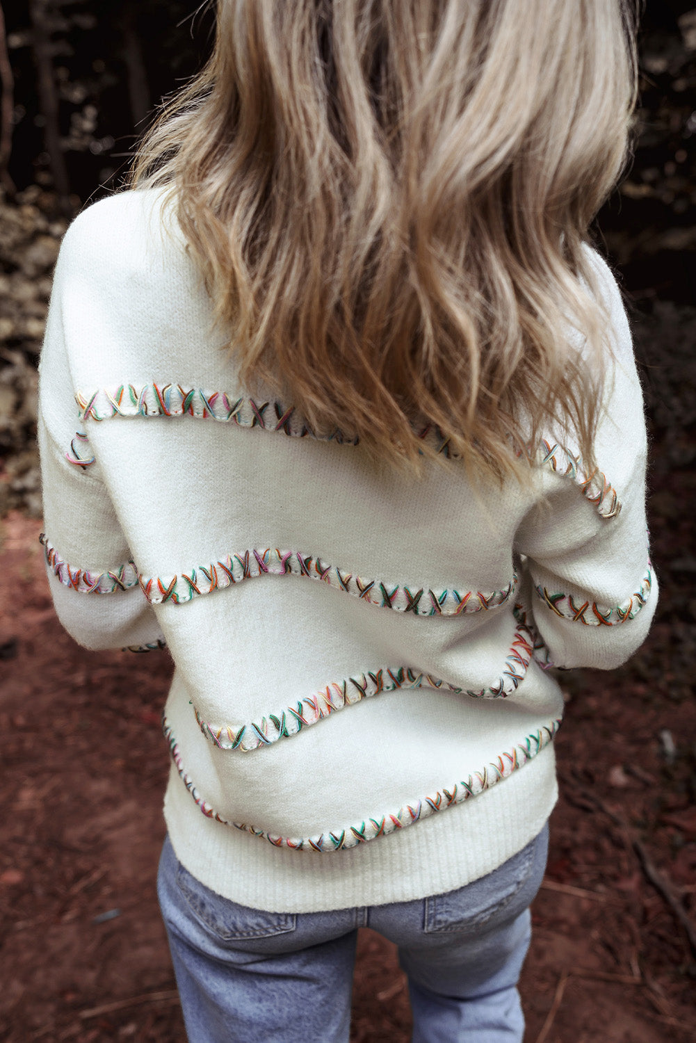 Colorful white sweater with dropped shoulders and crossed stitches