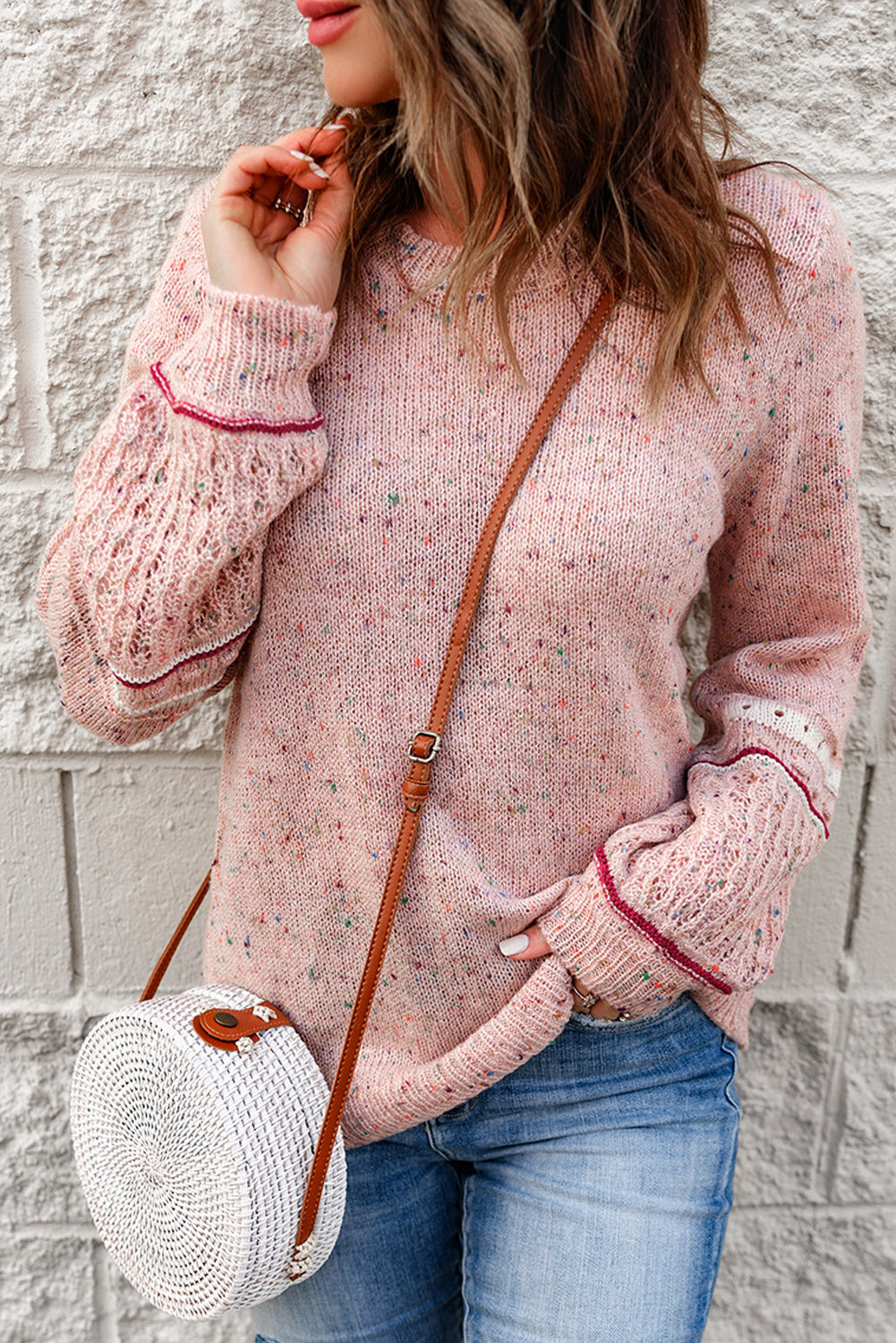 Pink sweater with patterned sleeves and pilled details