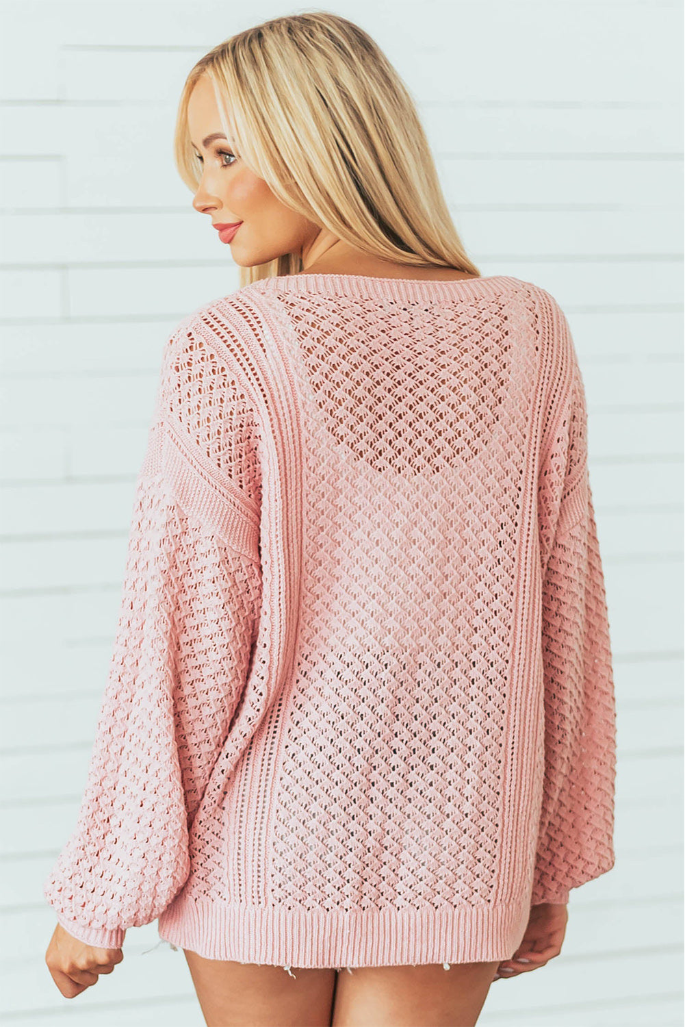 Rosa lose Pointeelle strickte gerippte V -Nackenpullover