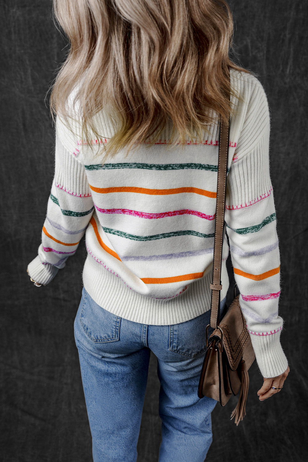 White sweater with colored stripes and ribbed borders