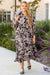 Long black dress with floral print and large puffing sleeves