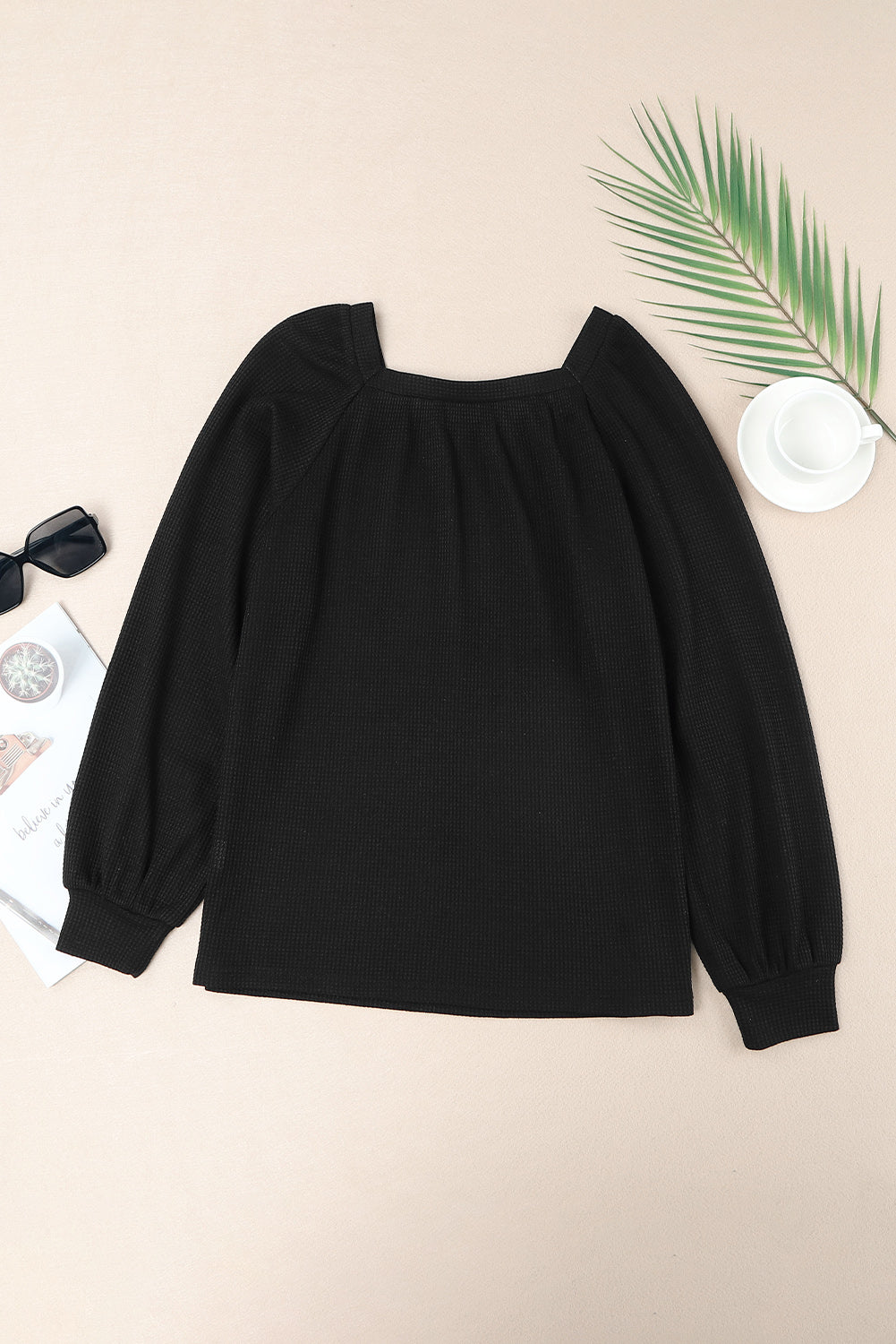 Black waffle knit top with puff sleeves and scoop neck