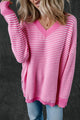 Loose V-neck sweater with pink striped slits