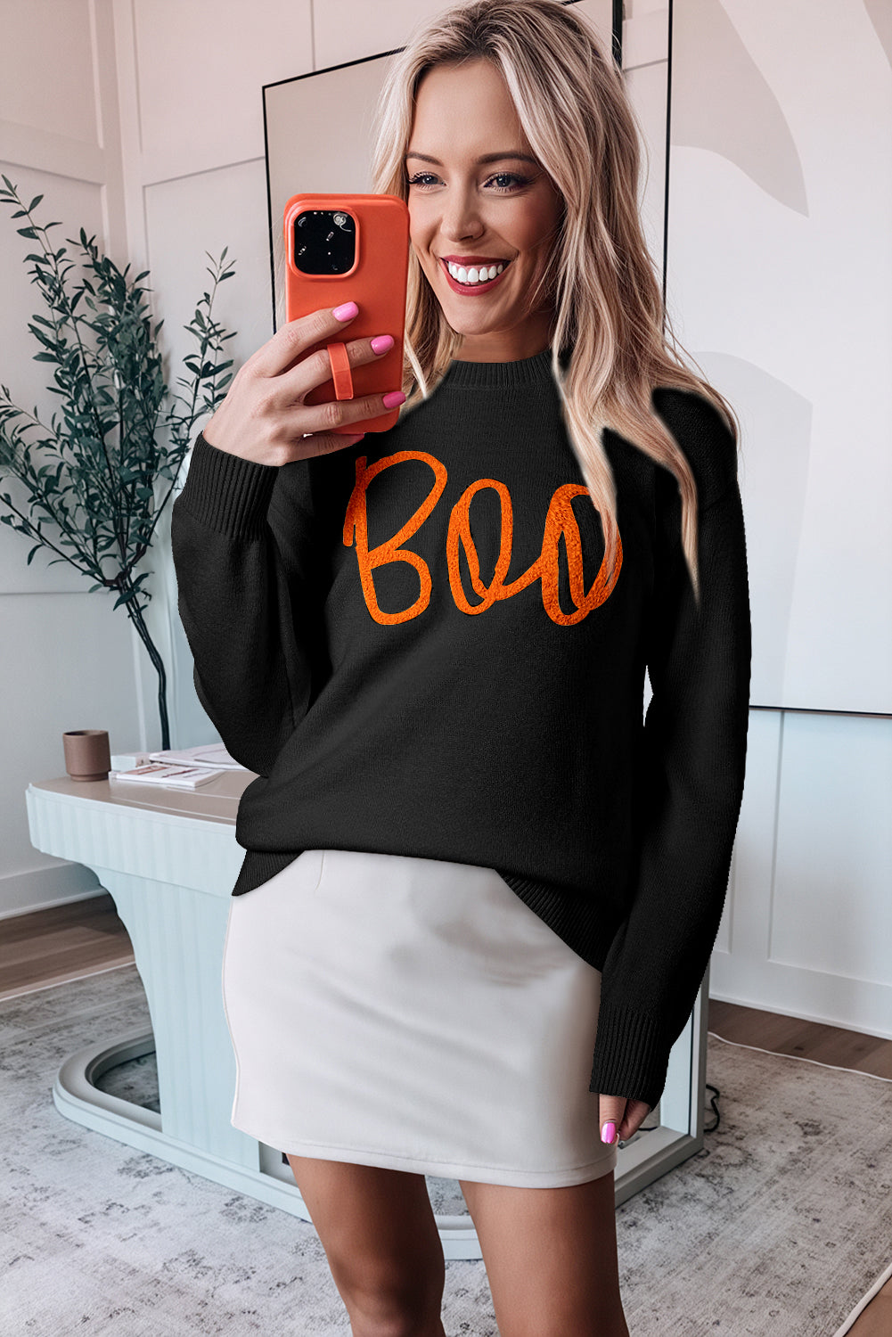 Black sweater with drooping shoulders and ribbed edges with Boo knitted pattern