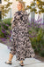 Long black dress with floral print and large puffing sleeves